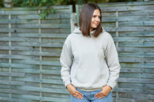 Young woman in beige hoodie. High quality photo